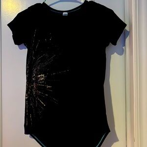 Ivivva black t shirt with a gold firework on the side.